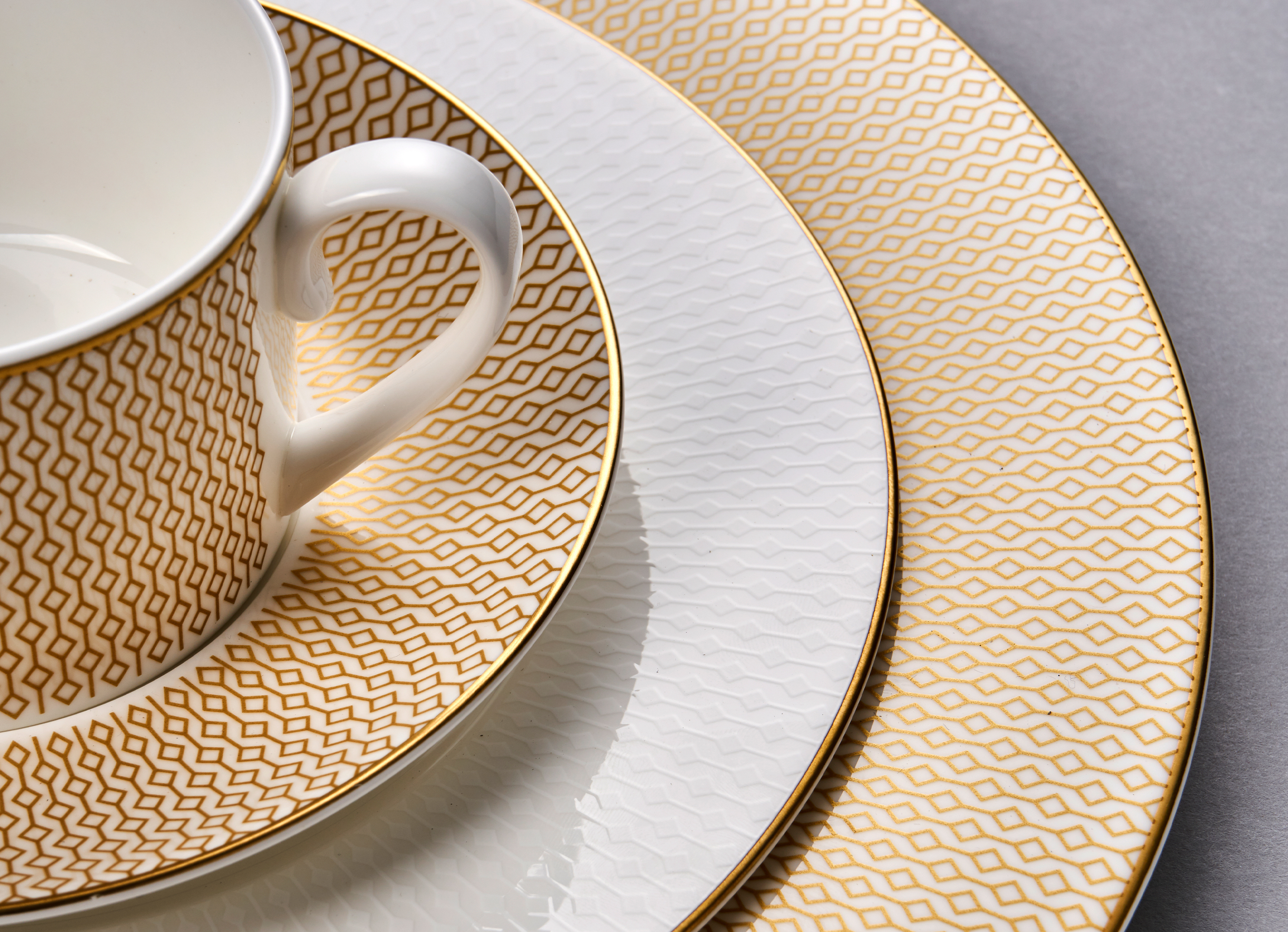Stack of signature Diamond collection plates with a cup