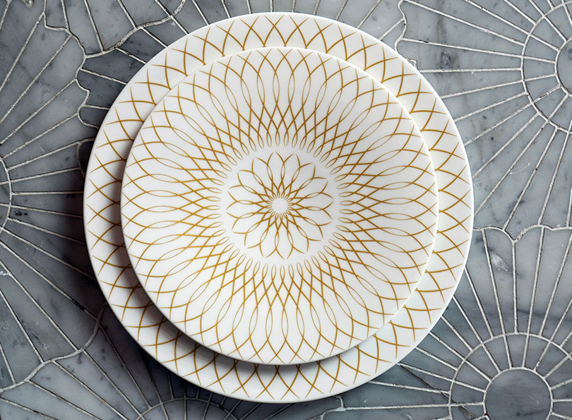 Stack of bespoke bone china plates for Atlantis Hotel, Dubai